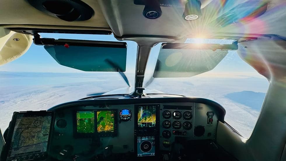 View of the cockpit of a Cessna 208B Grand Caravan in flight.