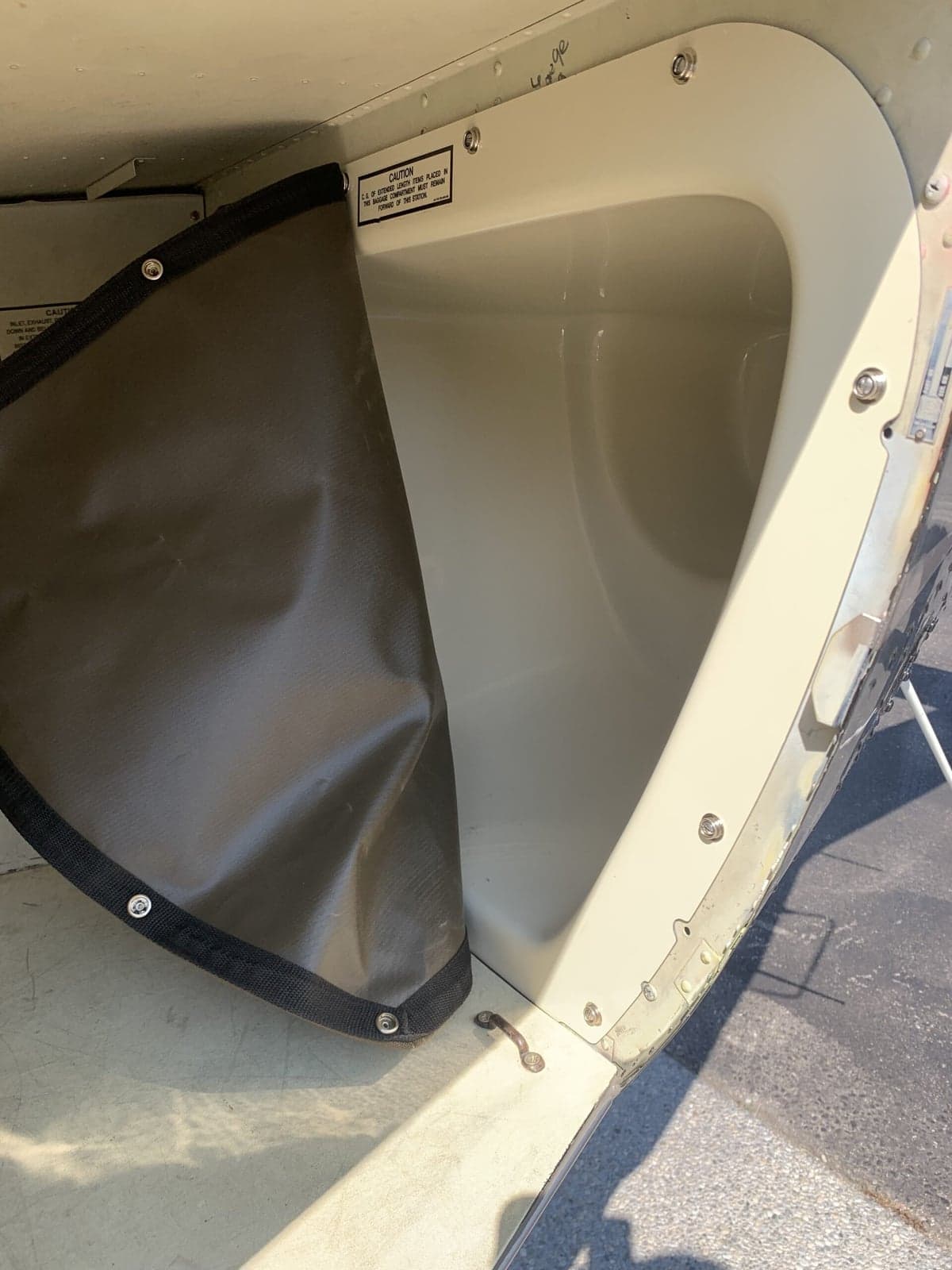 Close-up of an open storage compartment inside the Bell 407 helicopter.