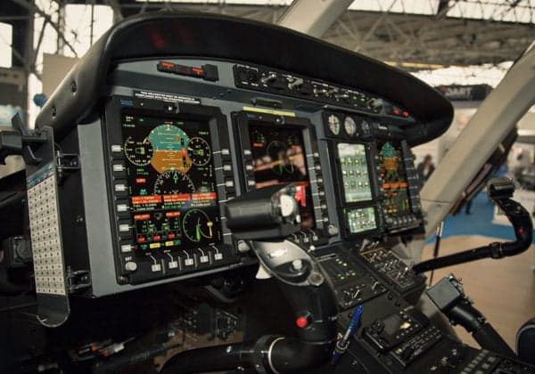 Close-up of the helicopter's instrument panel with multiple displays.