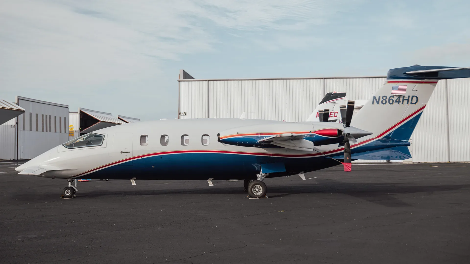 A Piaggio Avanti EVO aircraft with registration N864HD parked on the tarmac.