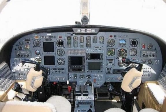 The cockpit of the aircraft features a gray instrument panel.