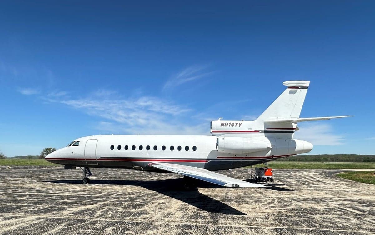 Side view of the N914TV aircraft parked on the tarmac.