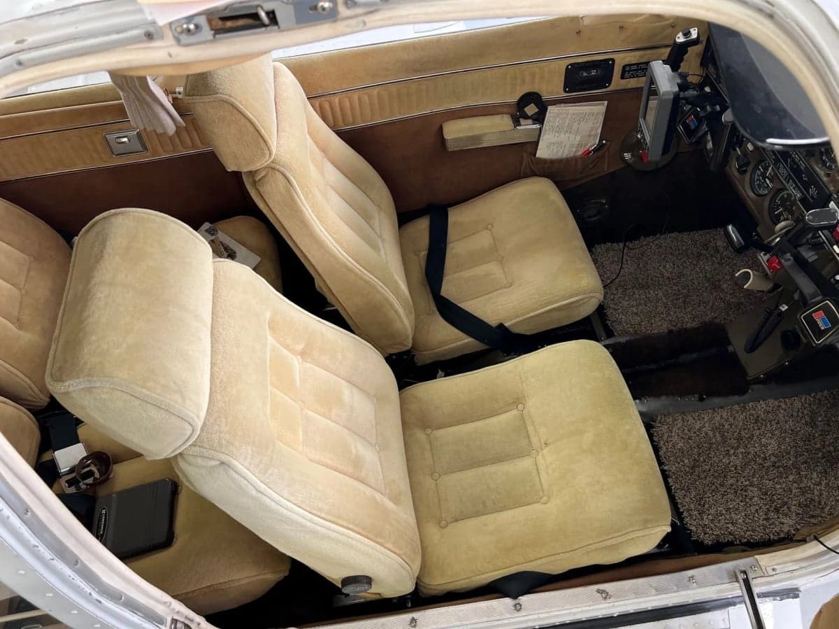Interior view of the aircraft cabin showing the seats and side panels.