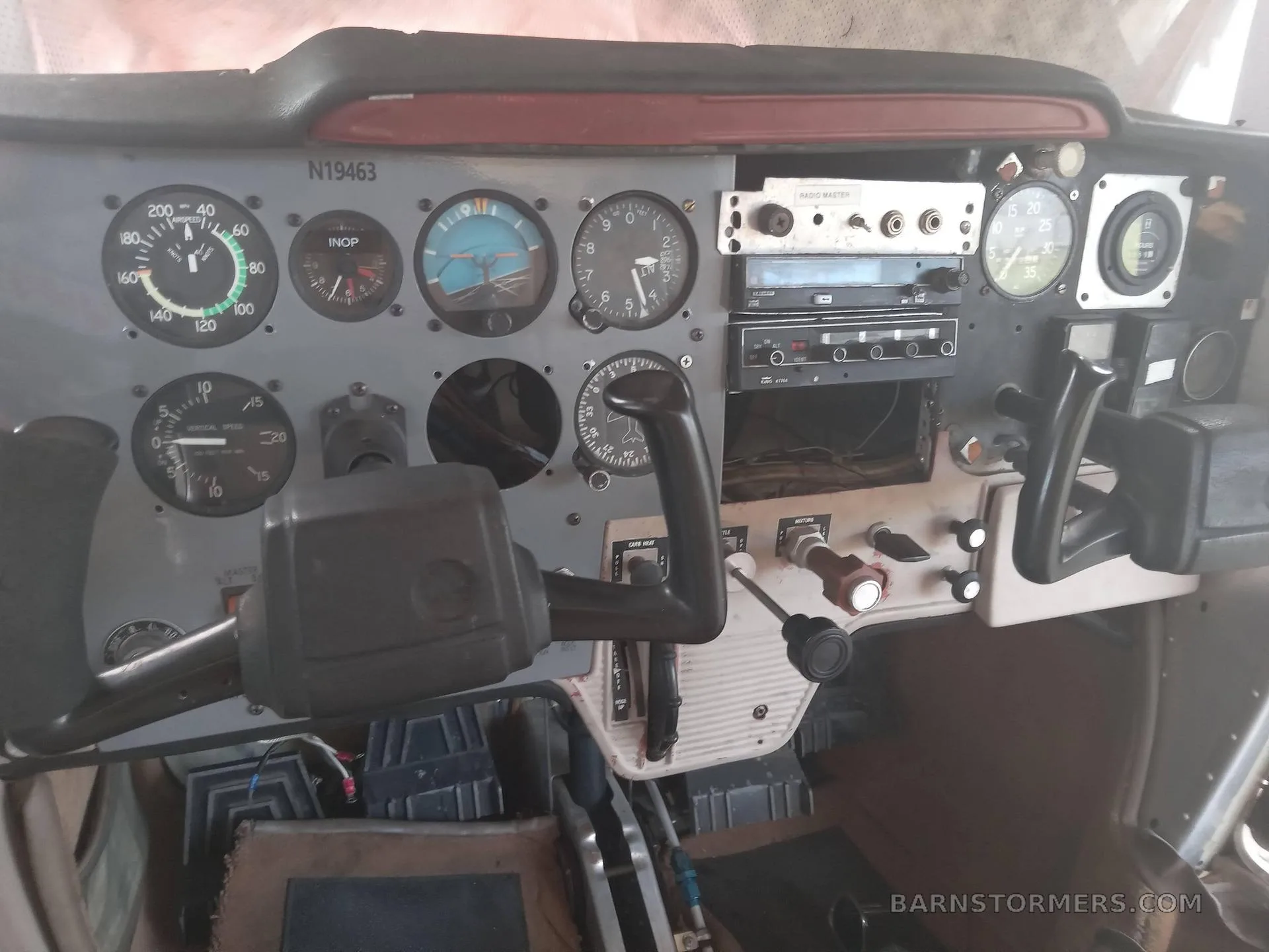 A close-up view of the instrument panel and yokes in a light aircraft cockpit.