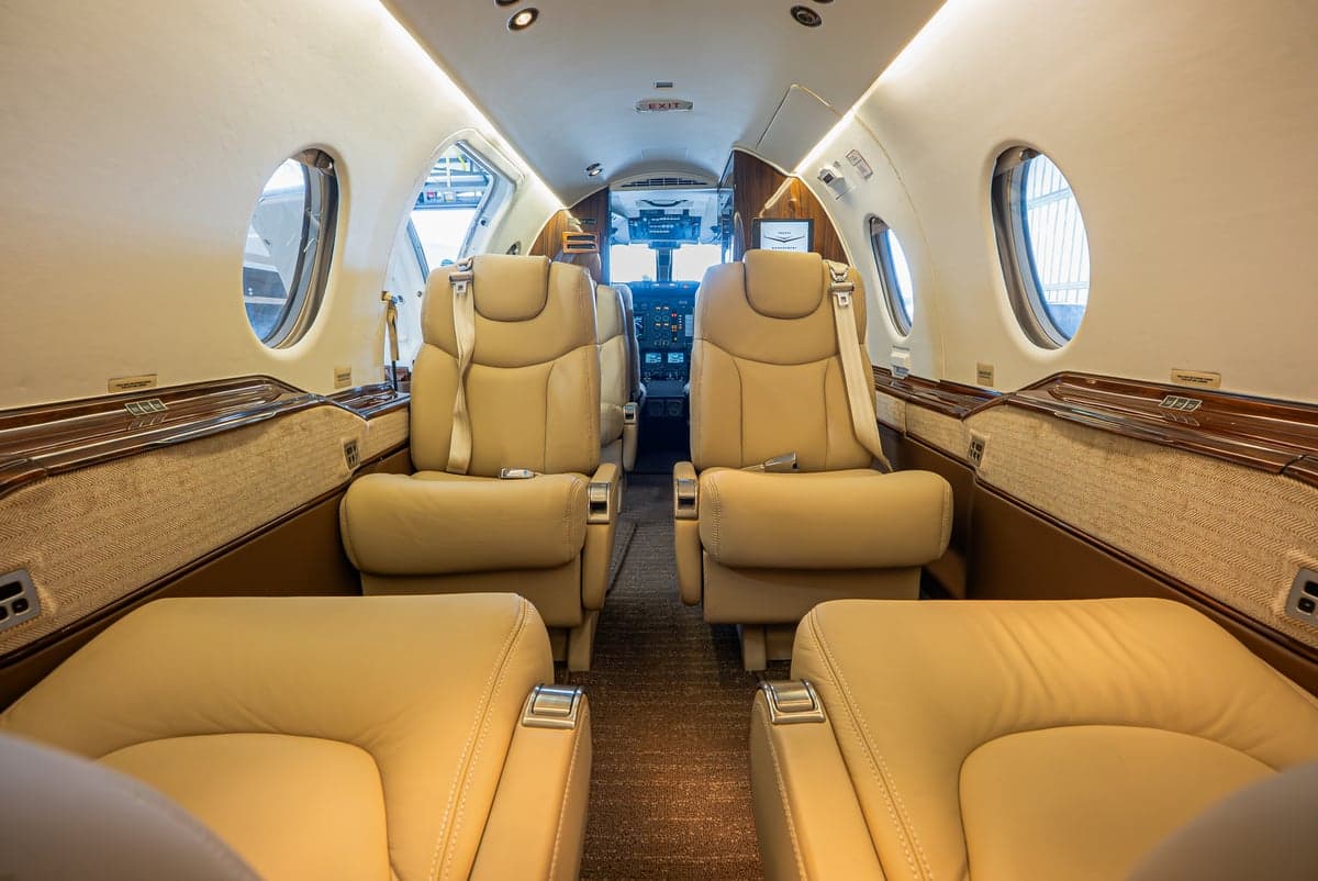 Forward view of the Learjet cabin with tan leather seats.