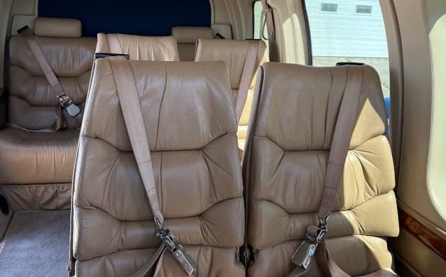 The cockpit of the helicopter with sheepskin seat covers.