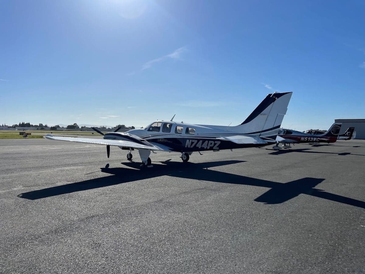 A Piper PA-31-350 Navajo Chieftain aircraft with a white and black paint scheme parked on the tarmac.