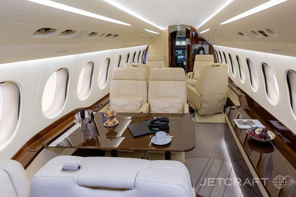 The aircraft's interior features a table with seating and amenities.