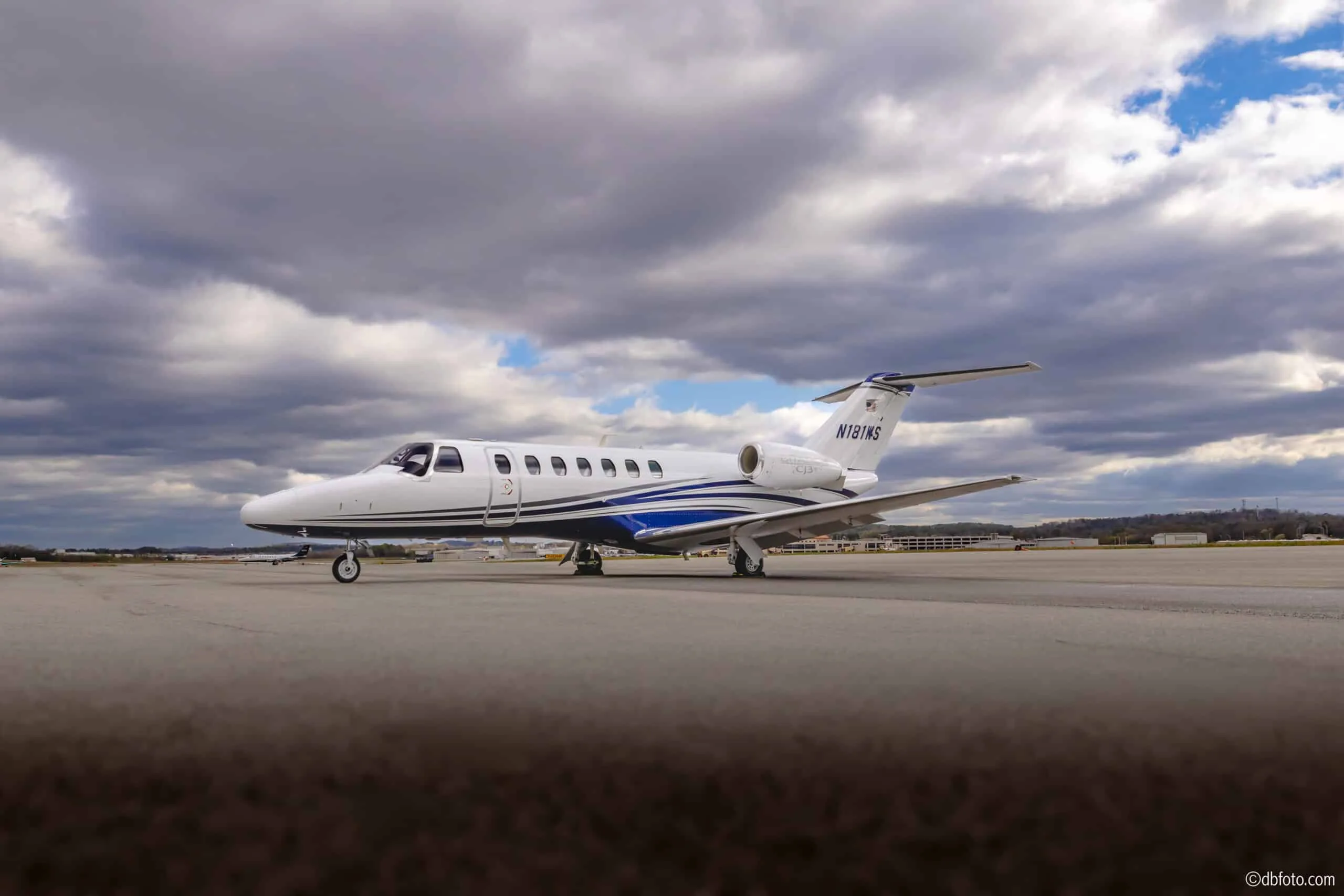 Side view of a Citation CJ3 aircraft with registration N181AS on the tarmac.