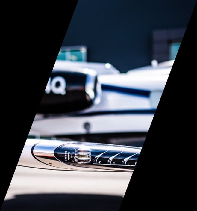 Close-up of the wingtip light and engine nacelle of a white and black jet.