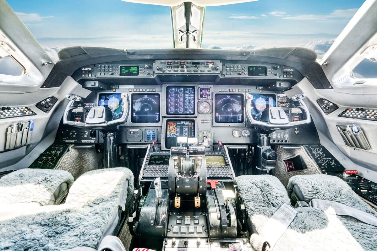 The aircraft's cockpit features a full instrument panel and sheepskin seat covers.