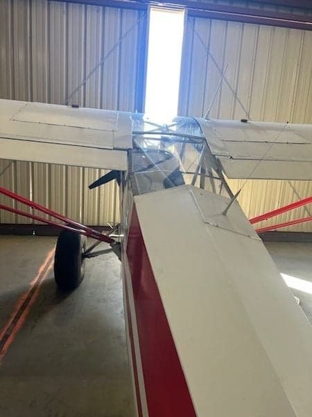 Aircraft N226T in a hangar, showing the red and white paint scheme.