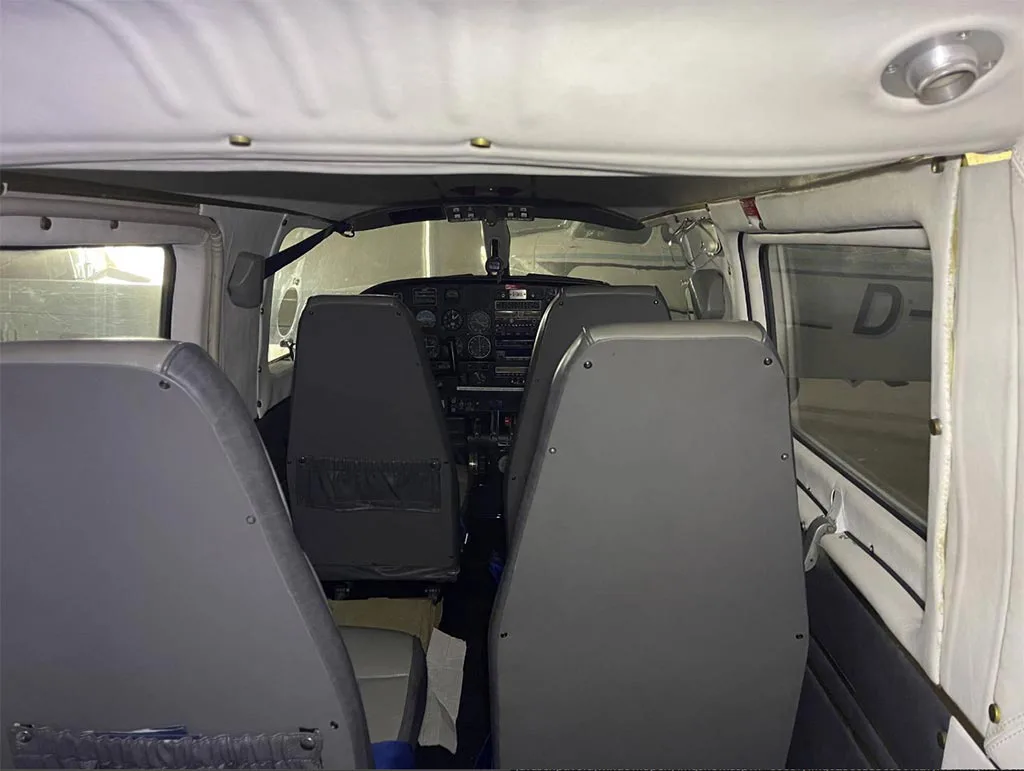 A view from the rear cabin looking forward into the cockpit of the aircraft.