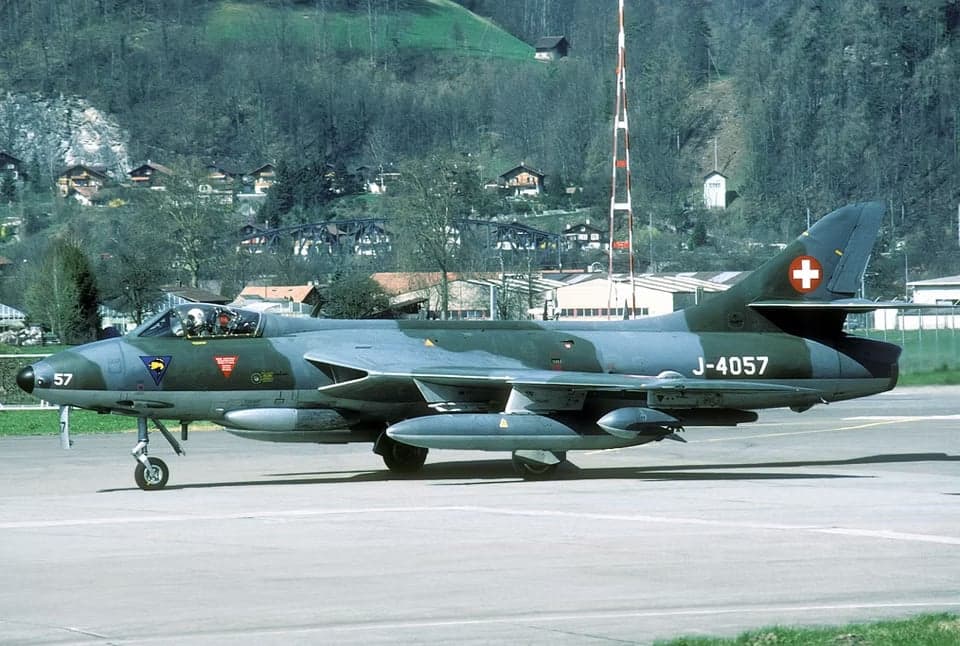 A Swiss Air Force Hawker Hunter, registration J-4057, parked on the tarmac.