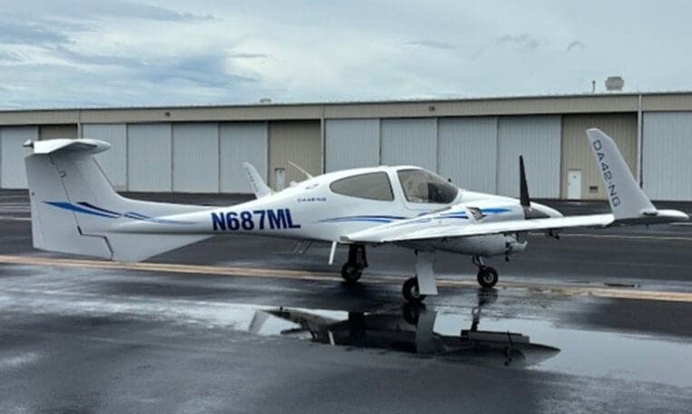 Diamond DA42-NG aircraft N687ML on the tarmac with reflection.