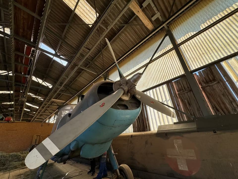 Tail section of the HB-HAB aircraft inside a hangar.