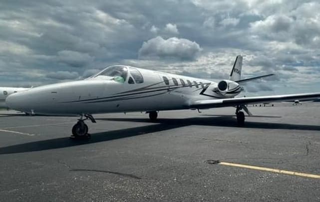 A Cessna Citation CJ4 aircraft with registration N704DA parked on the tarmac.