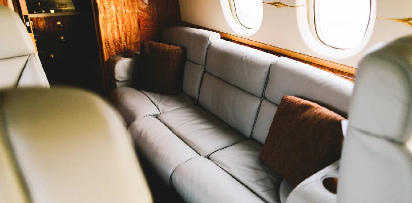 Interior of the aircraft featuring a couch with pillows.