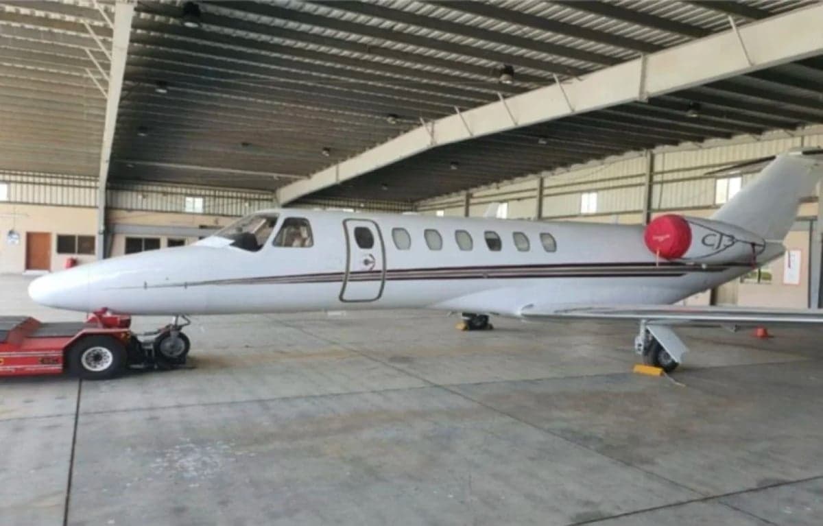 Side view of a Cessna Citation CJ3 in a hangar.