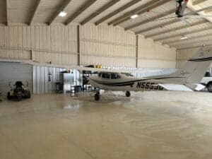 Cessna 172 Skyhawk with tail number N5555D parked inside a hangar.