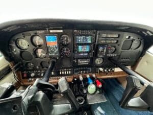The cockpit of a Cessna aircraft showing the instrument panel and controls.