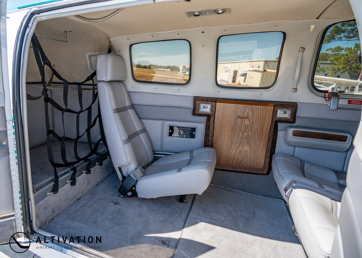 The interior of a Beechcraft Bonanza with gray leather seats.