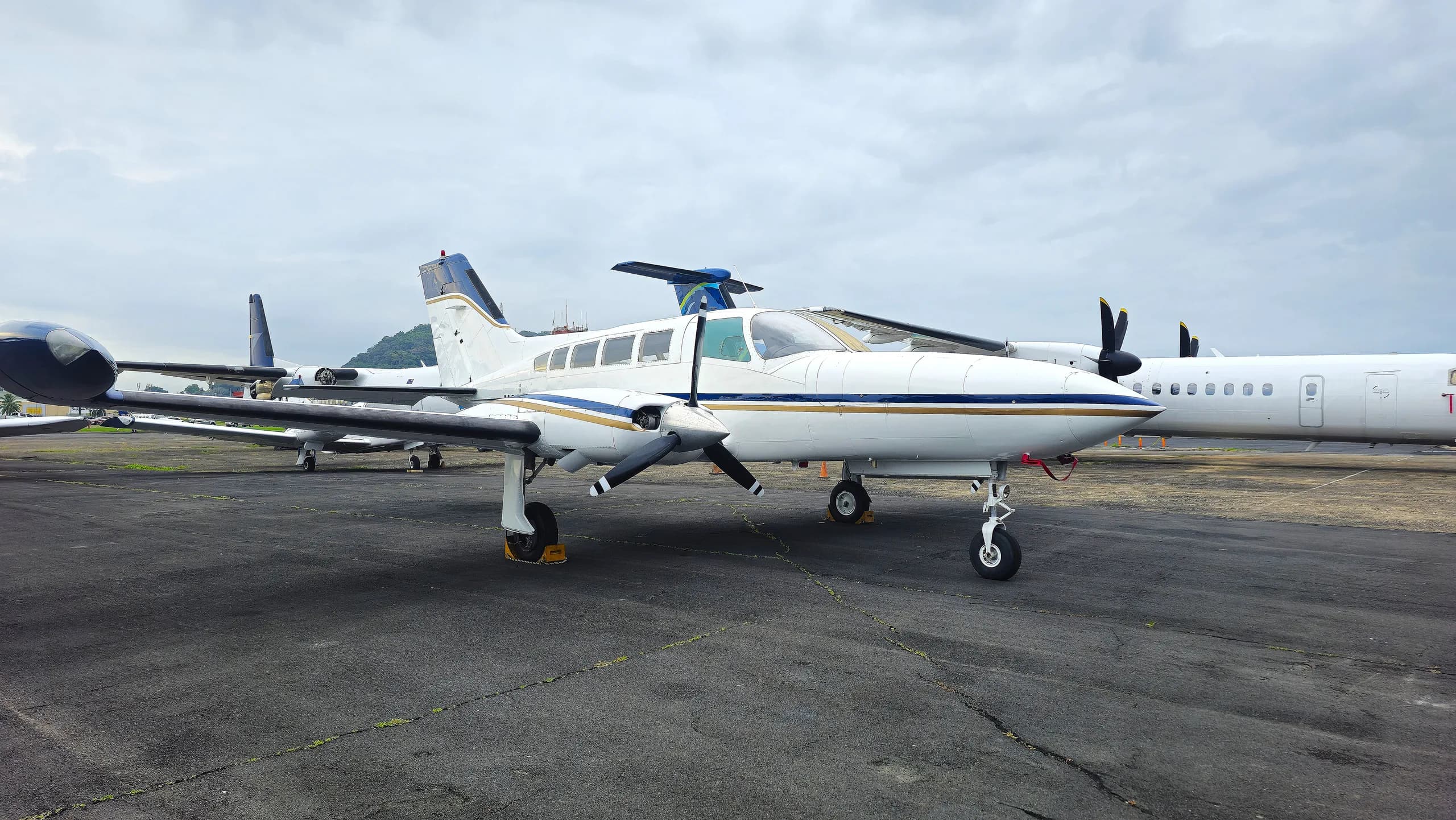 A twin-engine aircraft is parked on the tarmac.