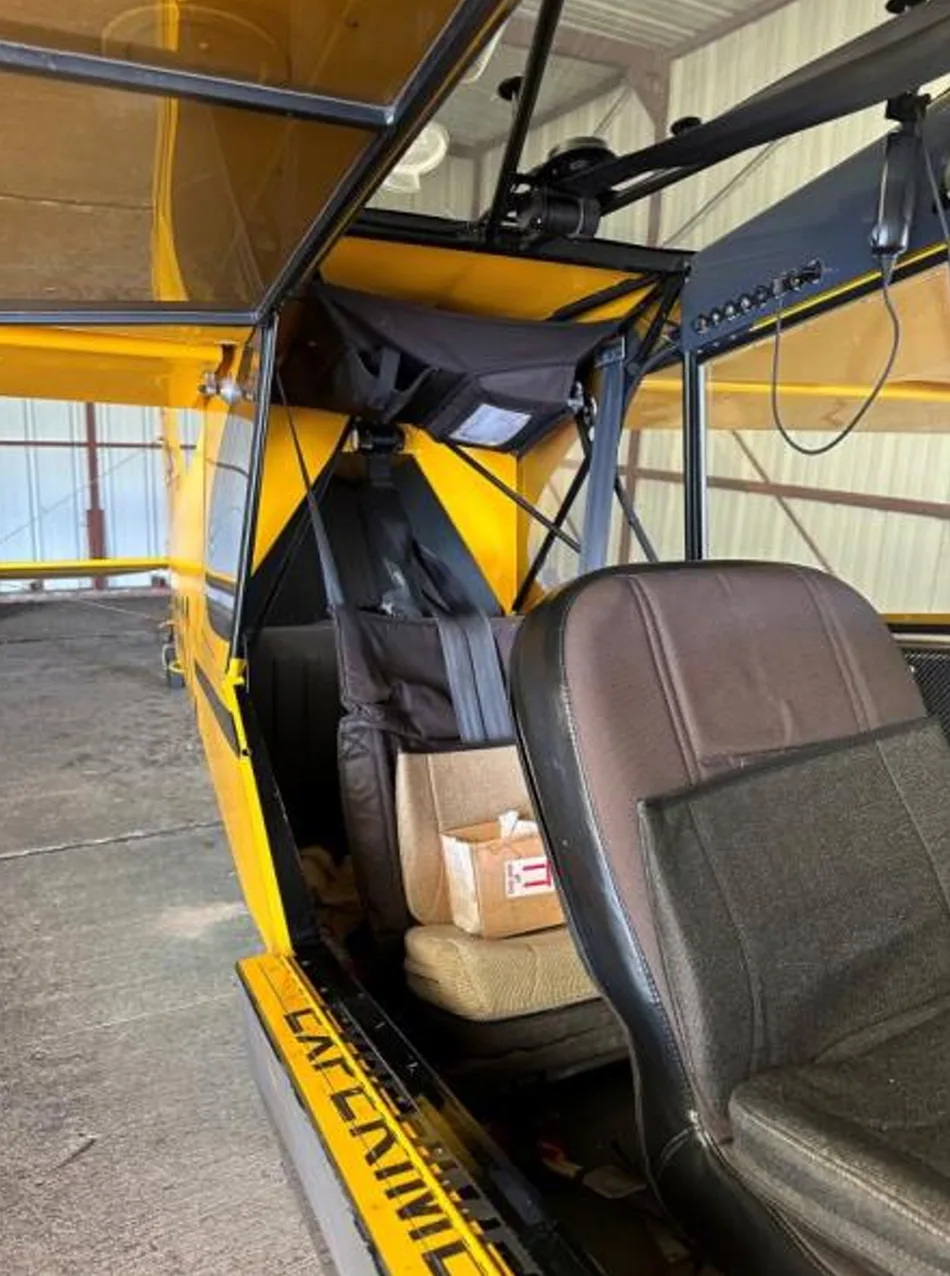 Interior view of the Carbon Cub aircraft showing the seats and frame.