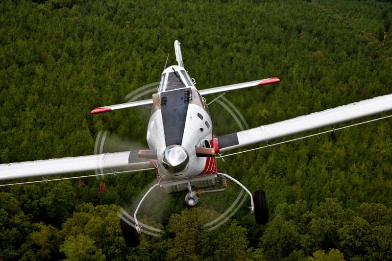 Front view of an Air Tractor 710P agricultural aircraft in flight.