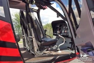 View of the cockpit with black seats and instrument panel.