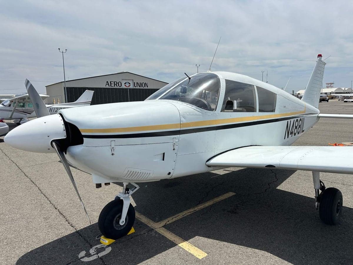 A Piper PA-28-140 Cherokee with tail number N4881L parked on the tarmac.