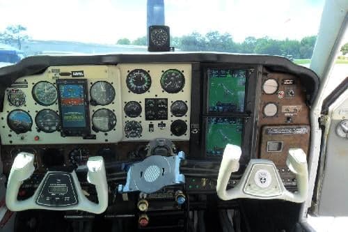 The aircraft's instrument panel and yokes are visible in the cockpit.