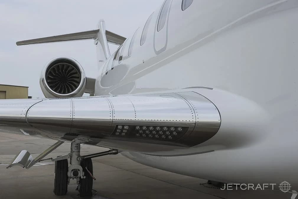 A close-up view of the right wing and engine of a white Bombardier Global 7500 business jet.