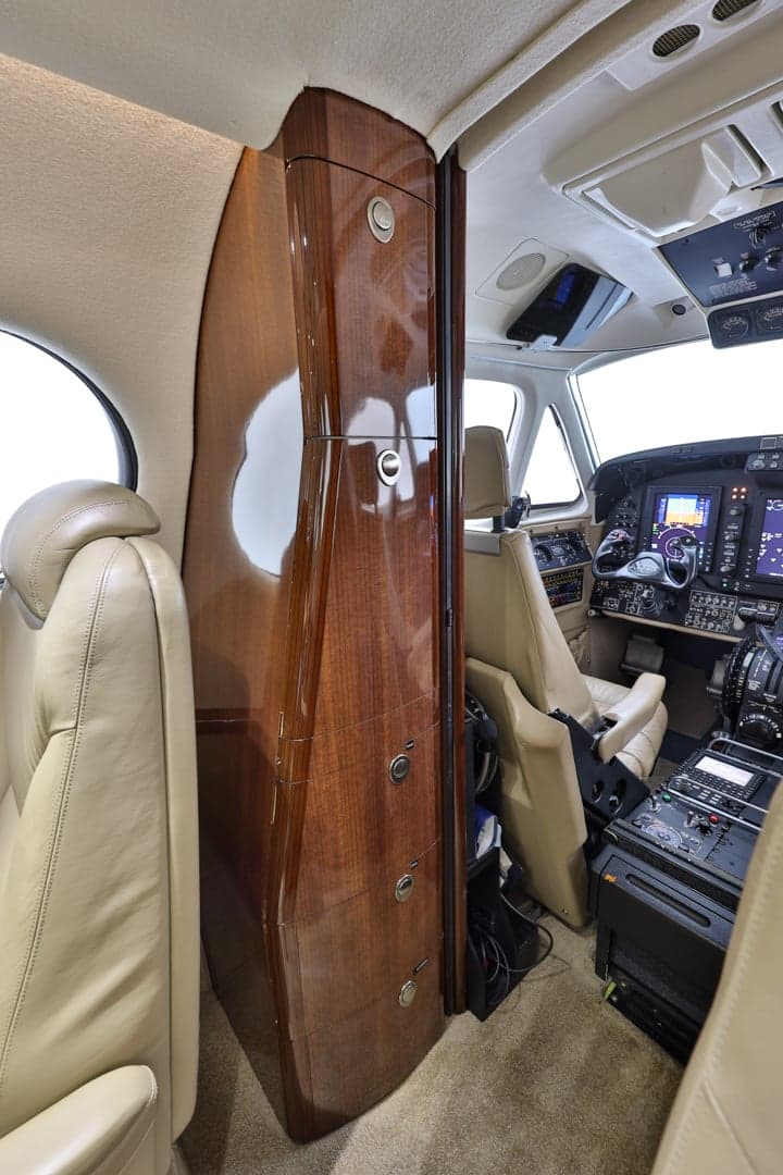 View of the King Air 350 cabin interior, showing the cabinetry and cockpit.