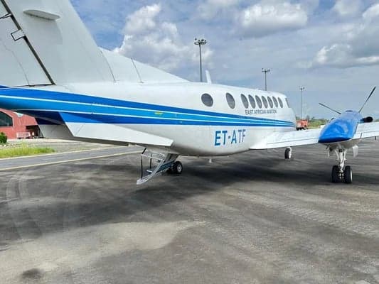 Side view of the King Air aircraft on the tarmac, showing the ET-ATF registration.