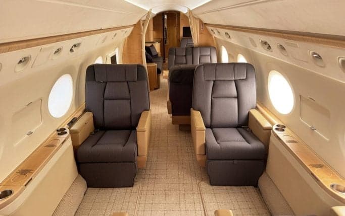 Forward cabin seating with two dark gray seats facing forward.