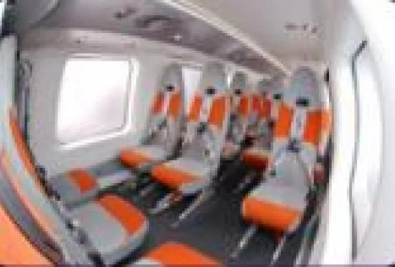 Interior view of the aircraft cabin with orange and gray seats.