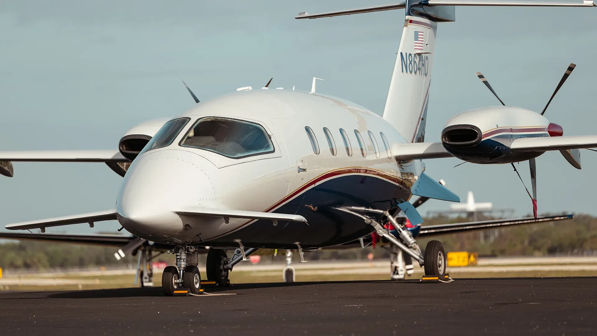 The front view of a Piaggio Avanti EVO aircraft with registration N864HD on the tail.