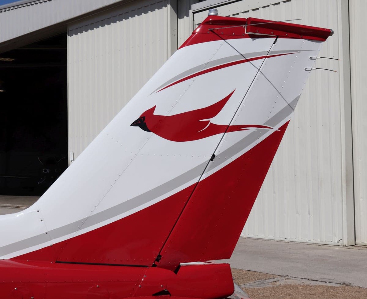Close-up of the tail section with a red bird logo.