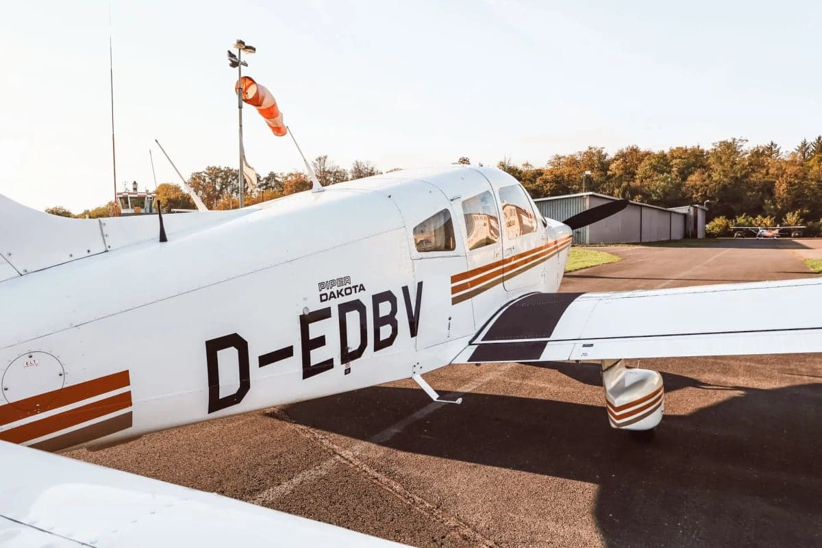 Piper Dakota D-EDBV with orange stripes parked on the tarmac.