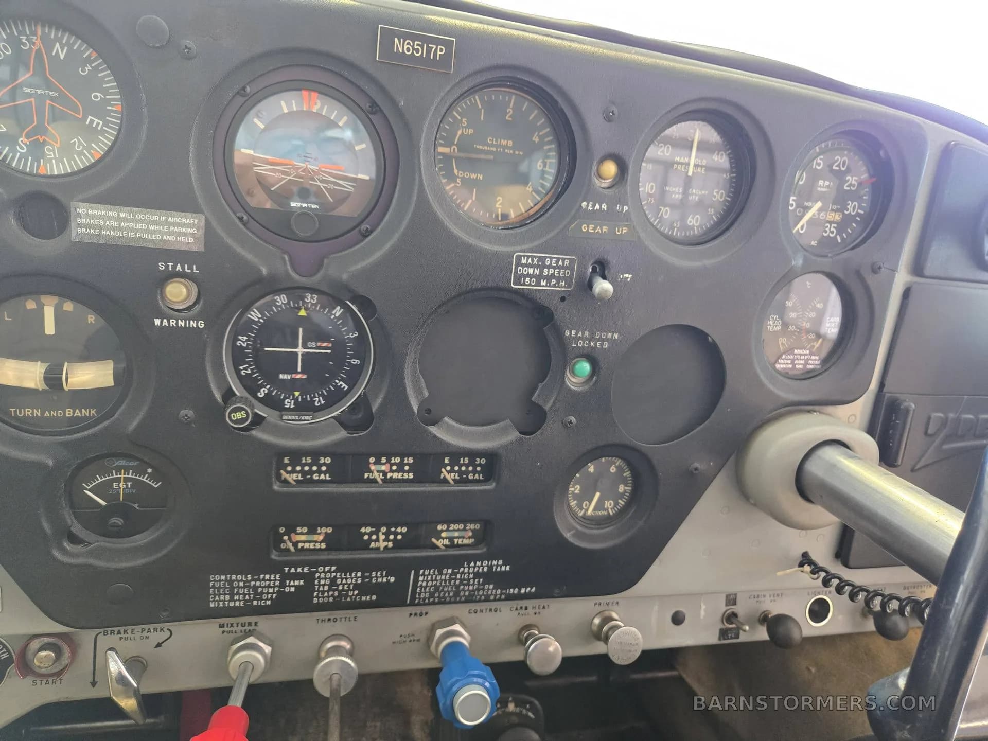 The instrument panel of a Piper Comanche 250 aircraft, showing various gauges and controls.