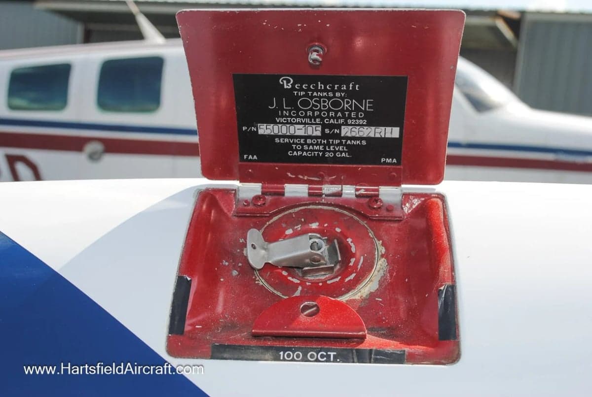 Close-up of the fuel filler cap on a Beechcraft Bonanza aircraft.