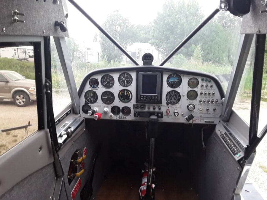 The cockpit of the Super Cub features a gray instrument panel with various gauges and controls.