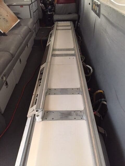 A view of the interior of the aircraft, showing a long, narrow storage area.