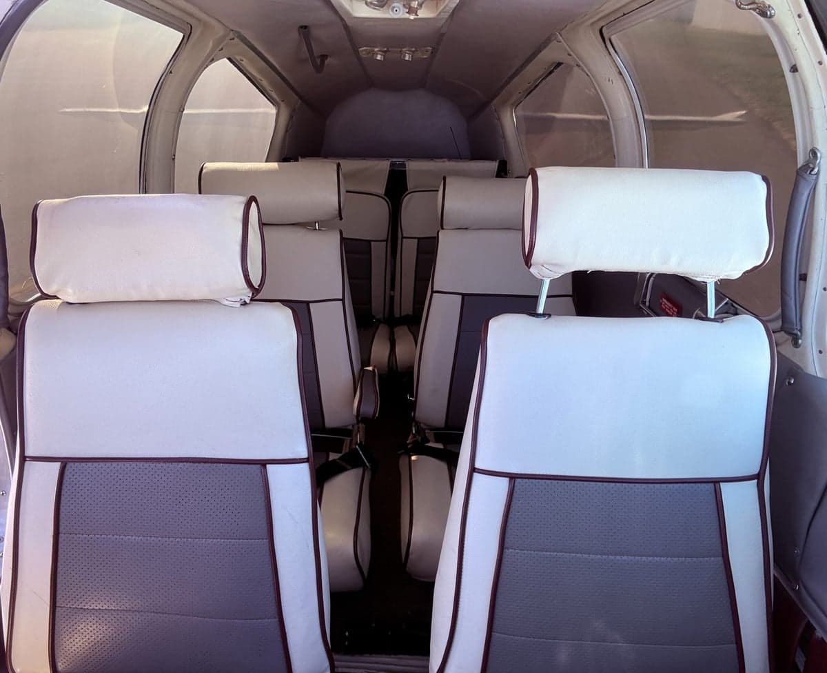 View of the aircraft's interior with white and gray seats.
