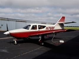 Side view of the N768F aircraft parked on the tarmac.