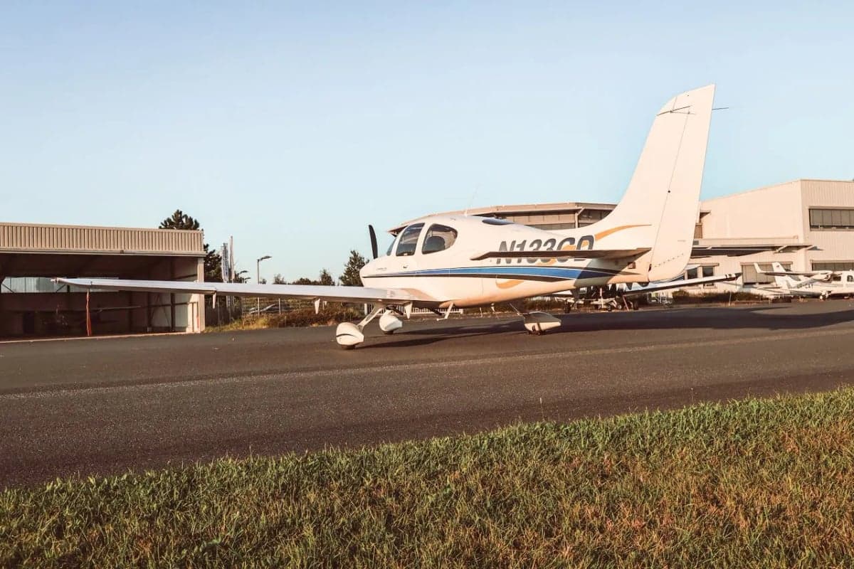 Cirrus SR22 aircraft N133CD parked on the tarmac, side view.