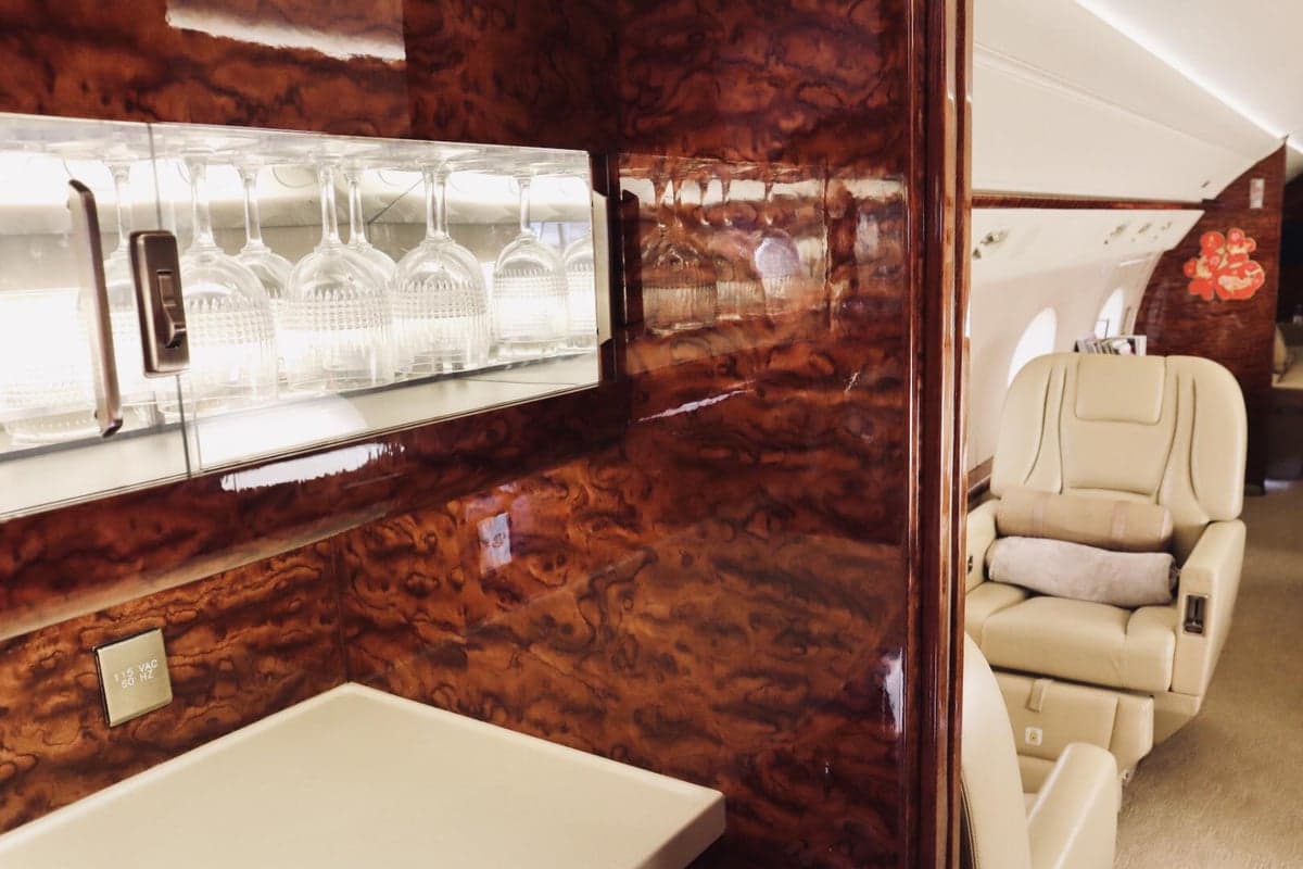 A view of the aircraft's interior, including a bar area and leather seats.