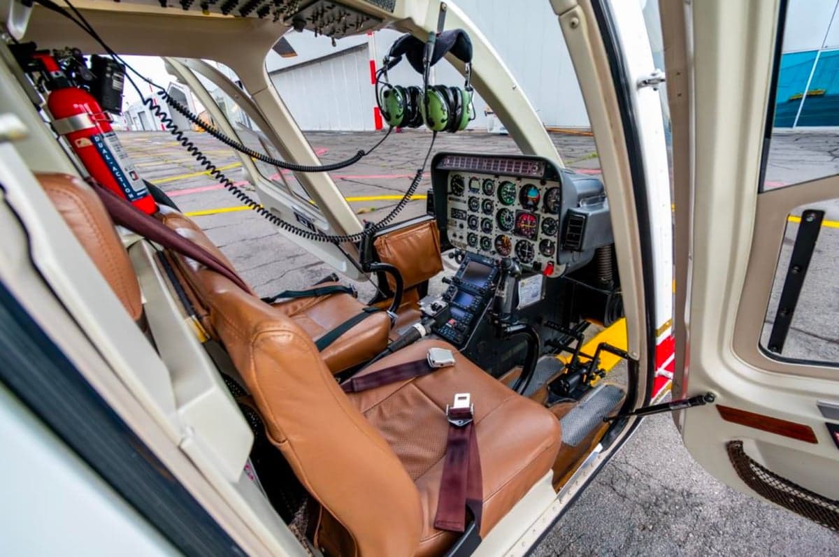 View of the cockpit with brown leather seats and instrument panel.