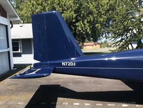 A close-up view of the dark blue tail of an aircraft, showing the tail number N72DJ.